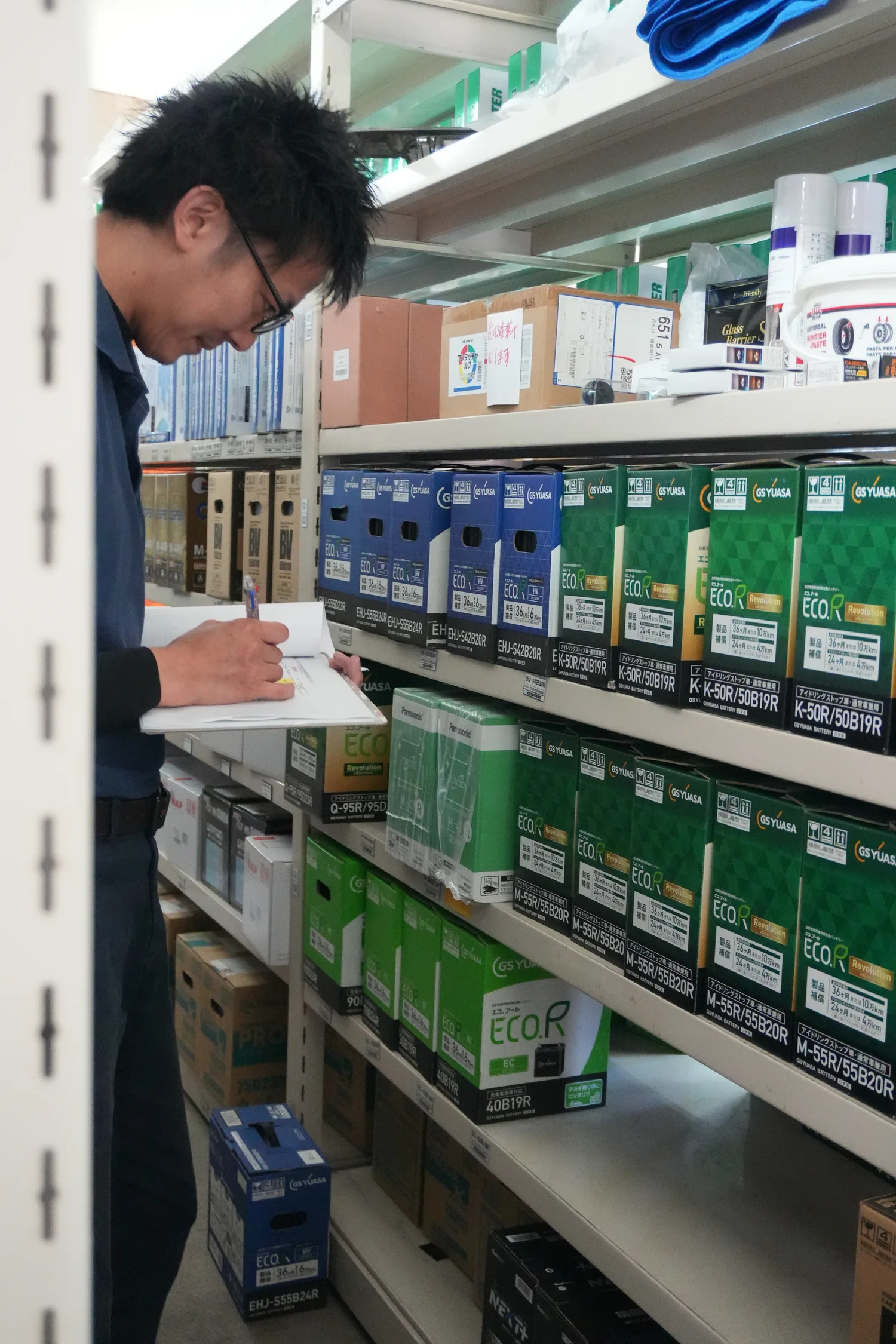 倉庫で部品を確認する社員